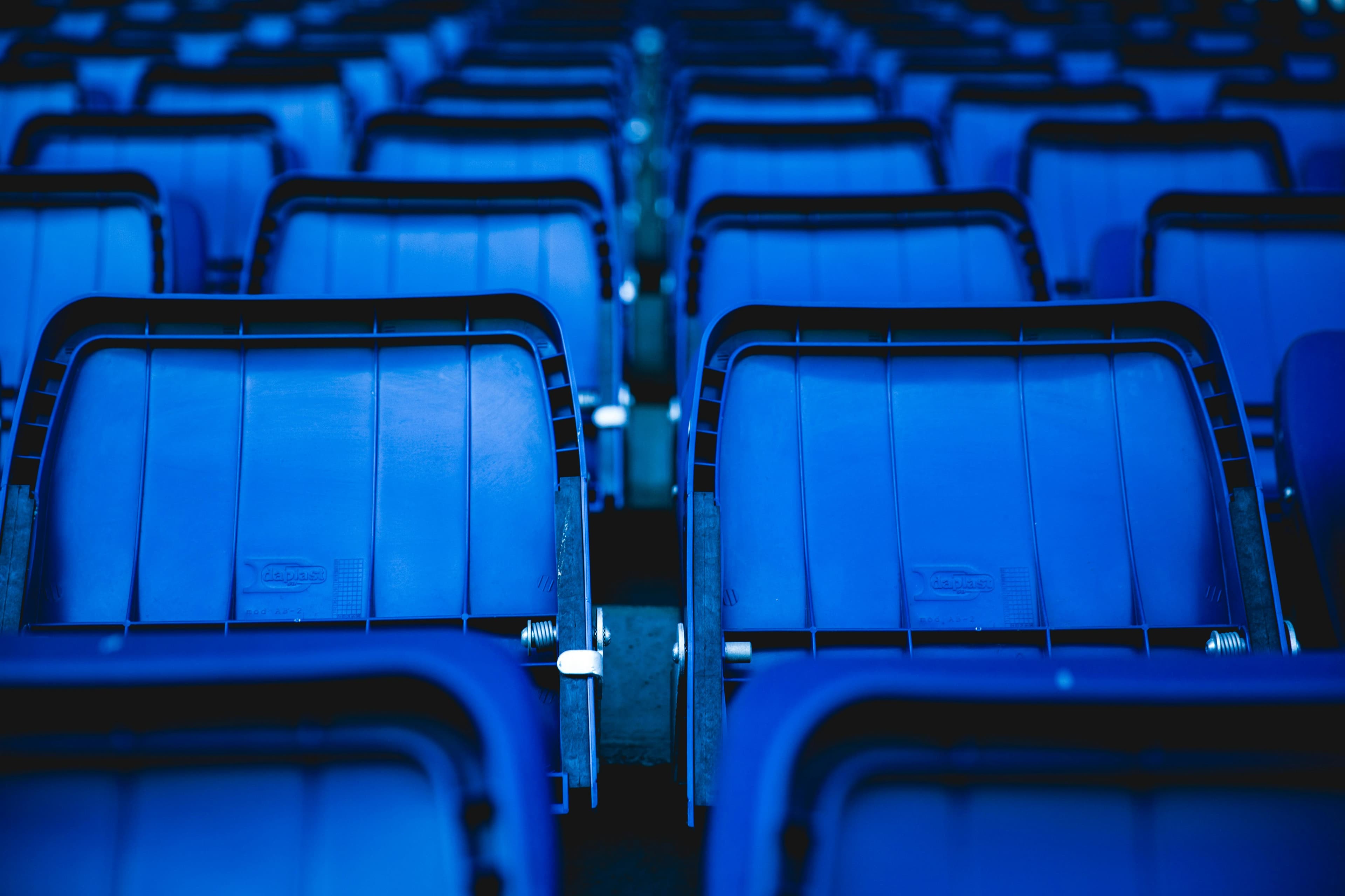Rows of empty stadium seating before an event.