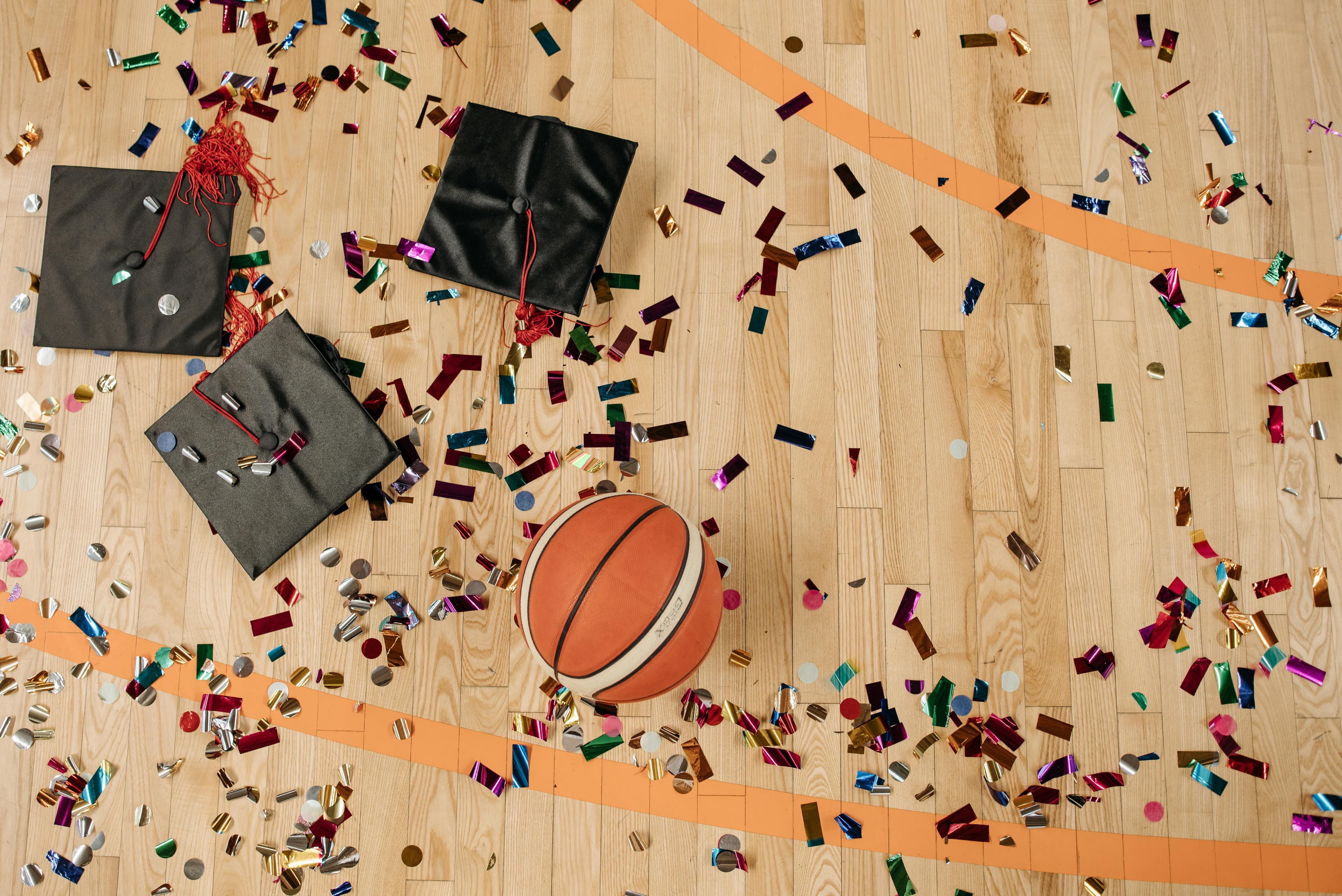 Graduation Caps On Basketball Court