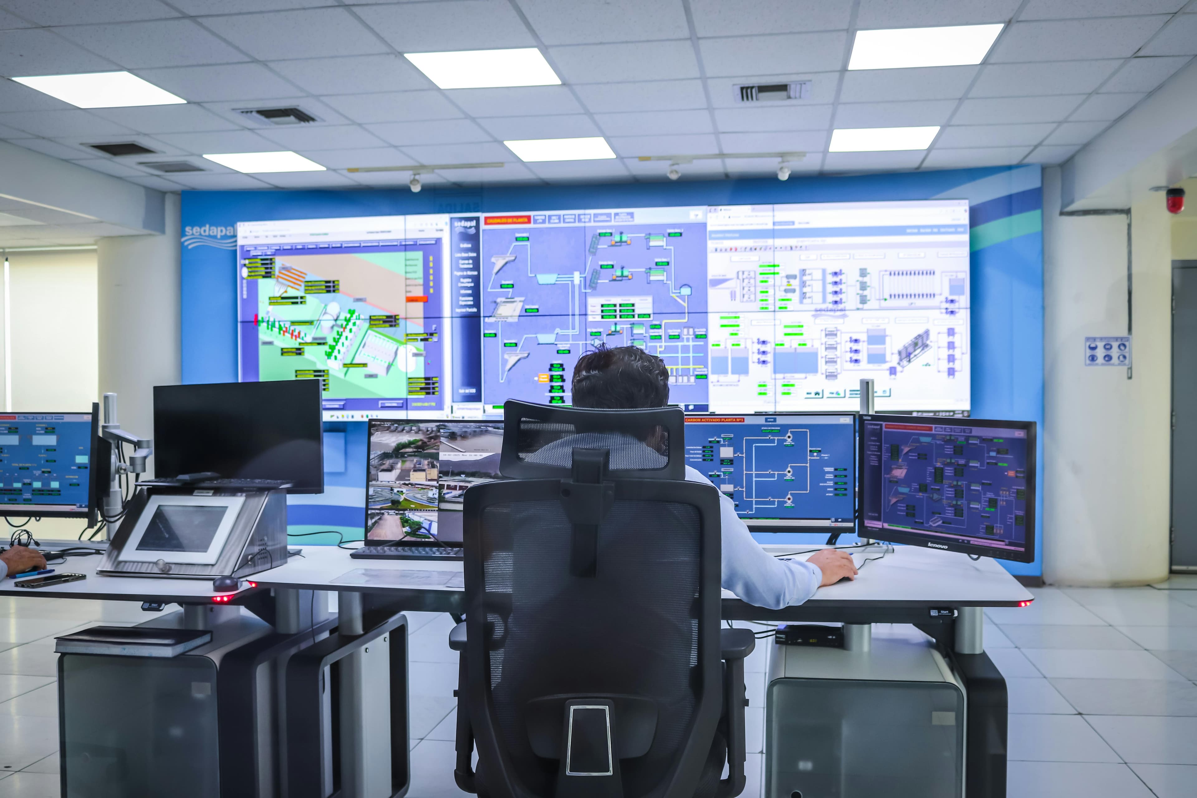 Man Sitting At Computer In Command Center
