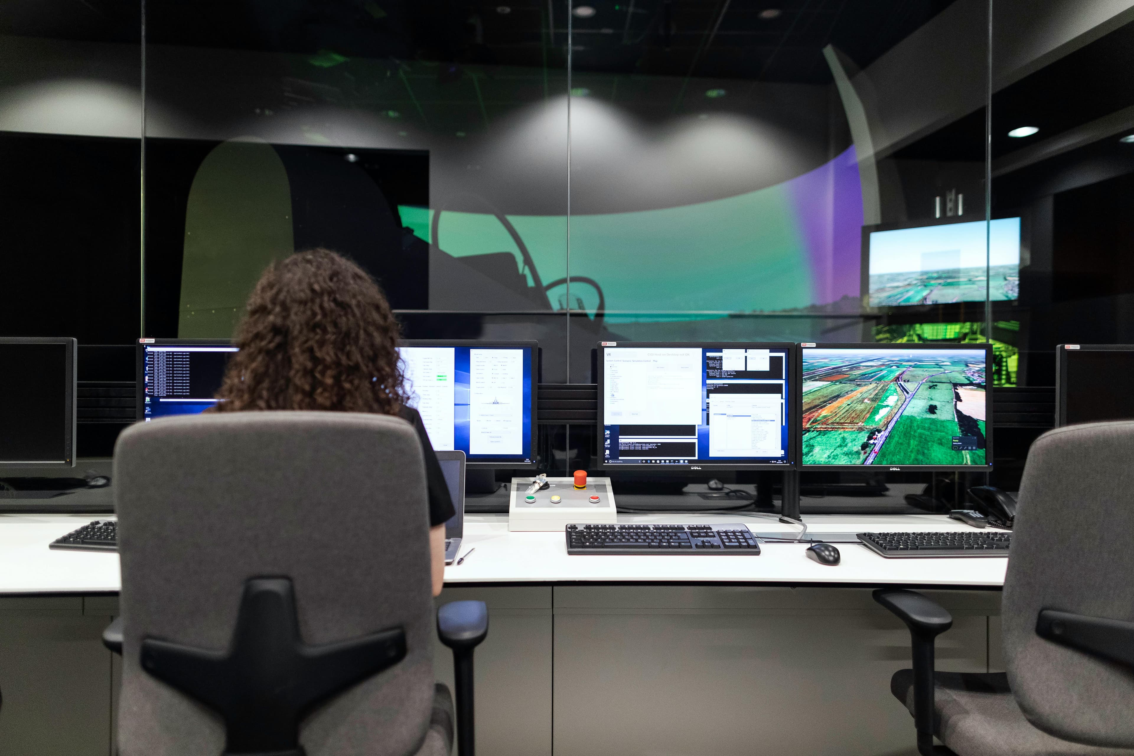 Woman Sitting At Computer In Command Center